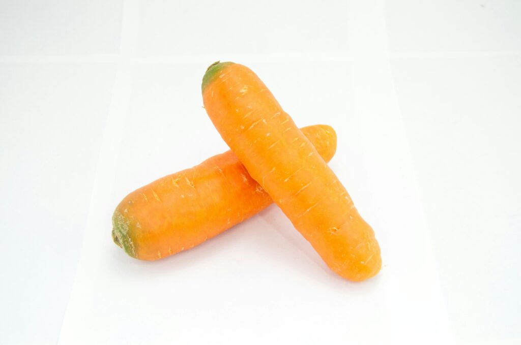 two baby carrots on top of each other